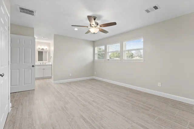 wooden floor in an empty room with a window