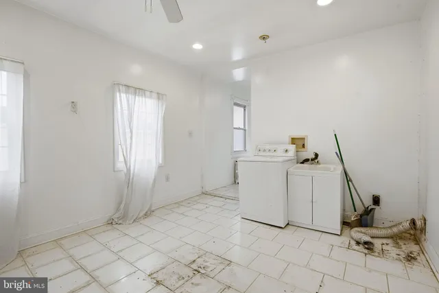 a view of kitchen with white cabinets