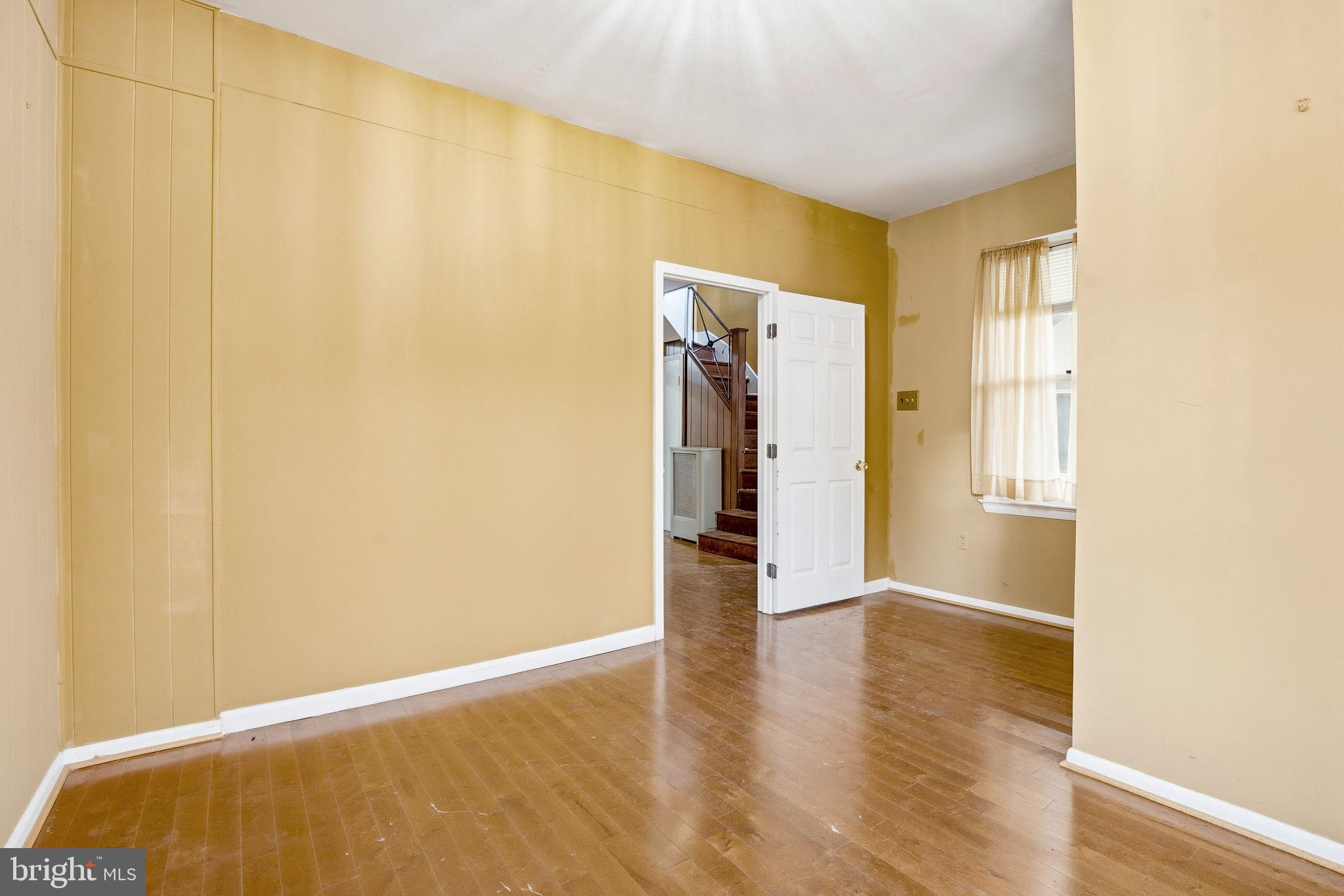1346 Franklin Street Northeast Washington, DC 20017 - Photo 5 of 50 a view of an empty room with wooden floor and a window