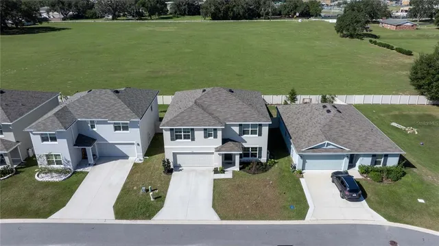 an aerial view of a house with outdoor space