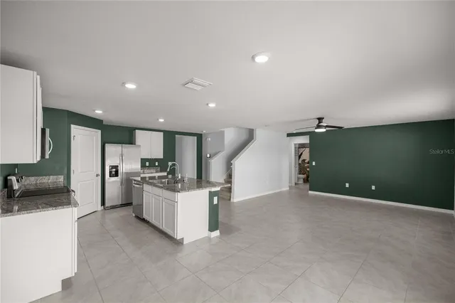 a view of a kitchen with a sink stove and cabinets