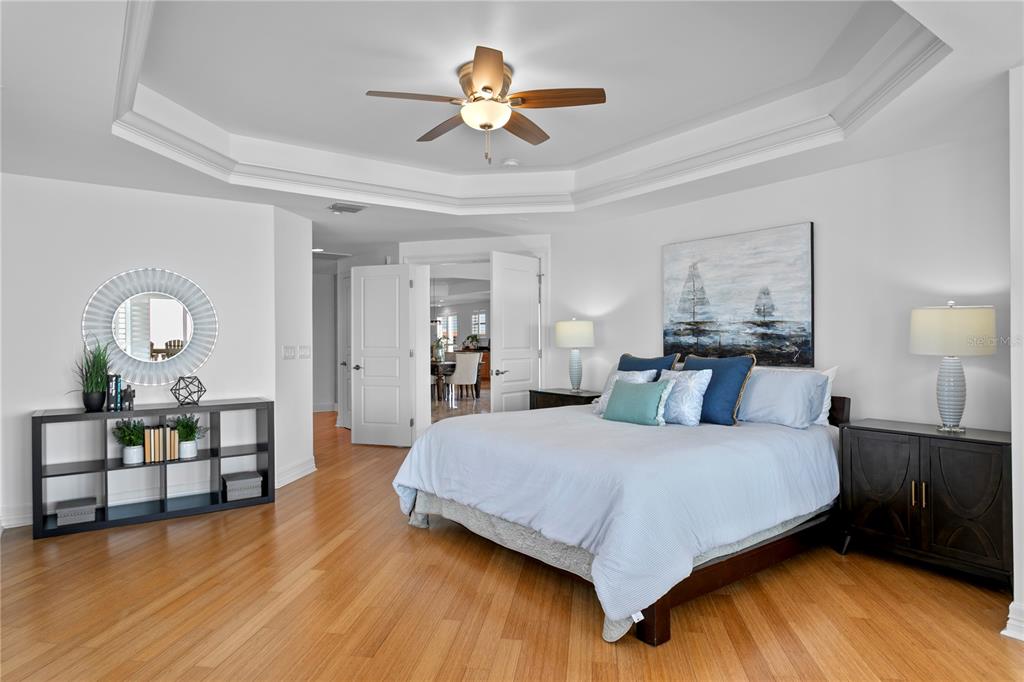 19730 Gulf Boulevard, Unit 400 Indian Rocks Beach, FL 33785 - Photo 42 of 90 a bedroom with a bed and a chandelier
