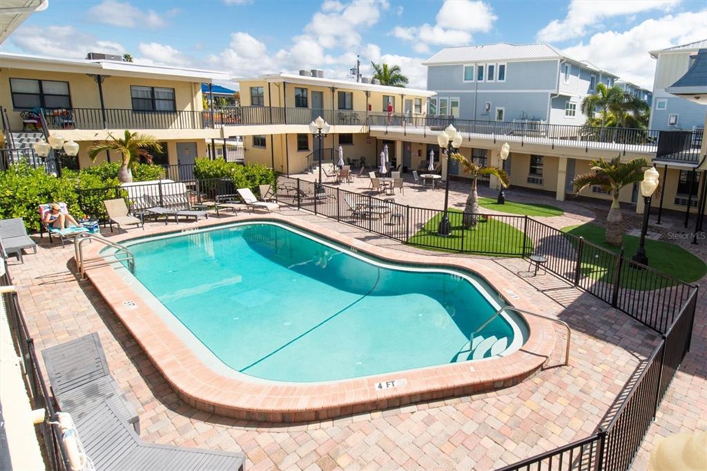 16333 Gulf Boulevard, Unit 201 Redington Beach, FL 33708 - Photo 14 of 39 a view of a swimming pool with a patio