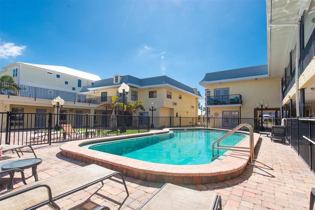 16333 Gulf Boulevard, Unit 201 Redington Beach, FL 33708 - Photo 15 of 39 a view of a swimming pool with a patio