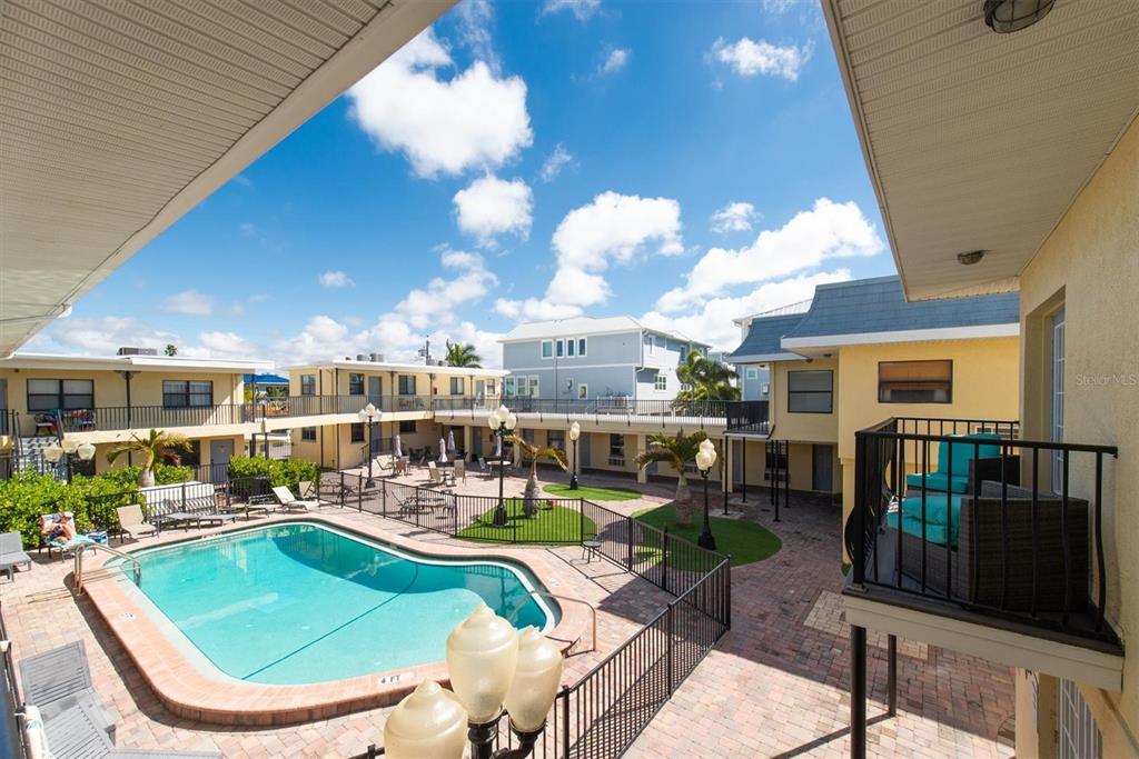 16333 Gulf Boulevard, Unit 201 Redington Beach, FL 33708 - Photo 16 of 39 a view of a swimming pool with outdoor seating