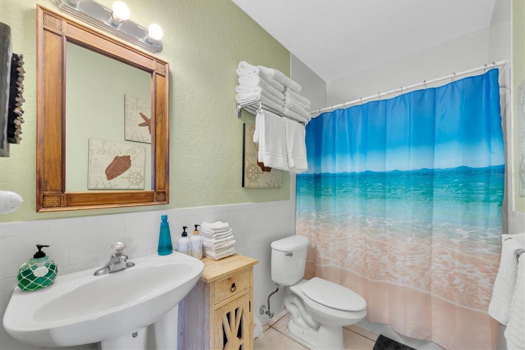 16333 Gulf Boulevard, Unit 201 Redington Beach, FL 33708 - Photo 19 of 39 a bathroom with a sink a toilet and shower