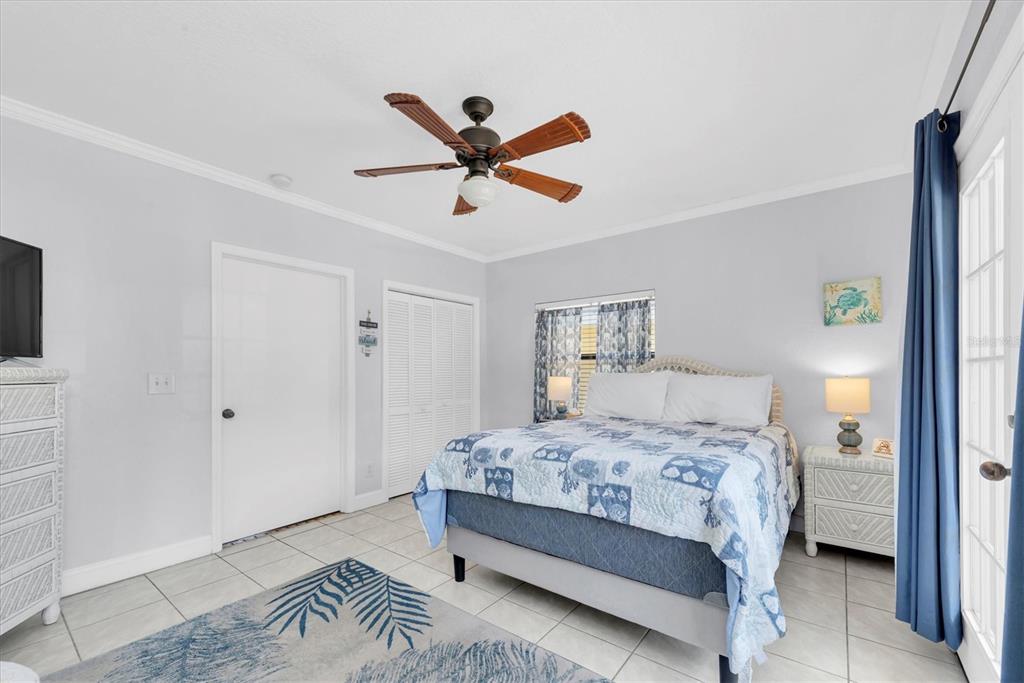 16333 Gulf Boulevard, Unit 201 Redington Beach, FL 33708 - Photo 23 of 39 a bedroom with a bed and a ceiling fan
