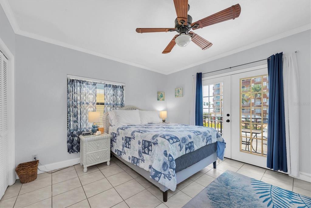 16333 Gulf Boulevard, Unit 201 Redington Beach, FL 33708 - Photo 25 of 39 a bed room with a bed and a chandelier