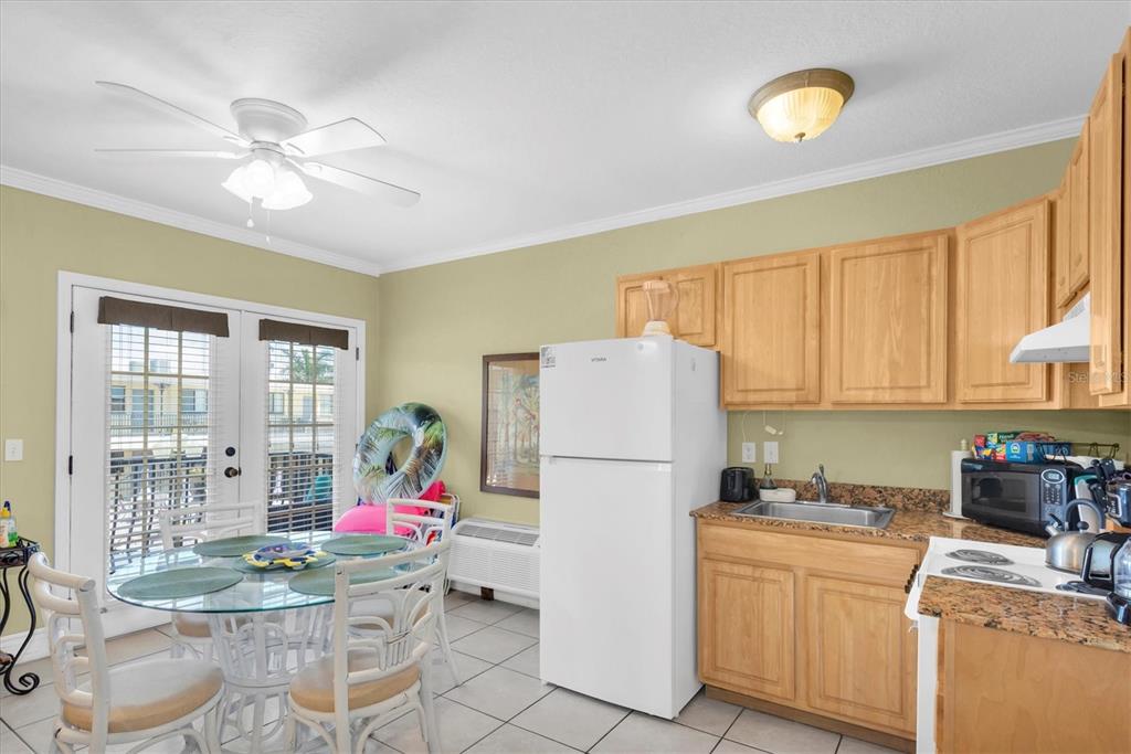 16333 Gulf Boulevard, Unit 201 Redington Beach, FL 33708 - Photo 26 of 39 a kitchen with a refrigerator and a stove top oven