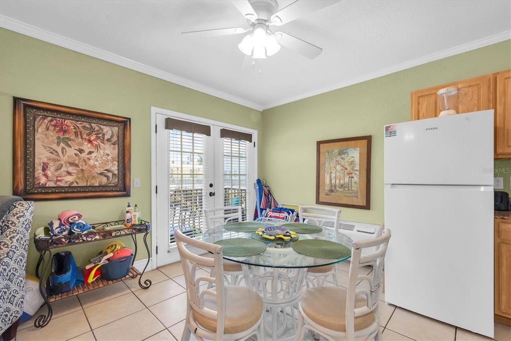 16333 Gulf Boulevard, Unit 201 Redington Beach, FL 33708 - Photo 31 of 39 a view of a dining room with furniture and a chandelier