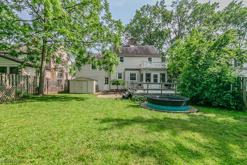 5195 Mayview Road Cleveland, OH 44124 - Photo 11 of 49 Rear view of property with a storage unit, a fenced backyard, stock tank pool and a deck