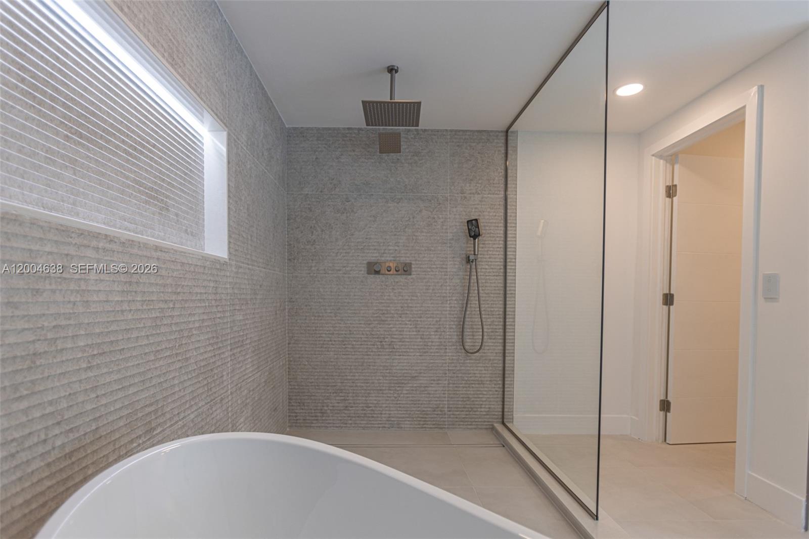 1690 Daytonia Road Miami Beach, FL 33141 - Photo 65 of 88 a bathroom with a shower and bathtub