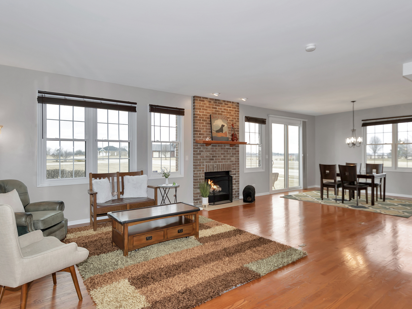 23928 Roberts Street Manhattan, IL 60442 - Photo 13 of 36 a living room with fireplace furniture and a large window
