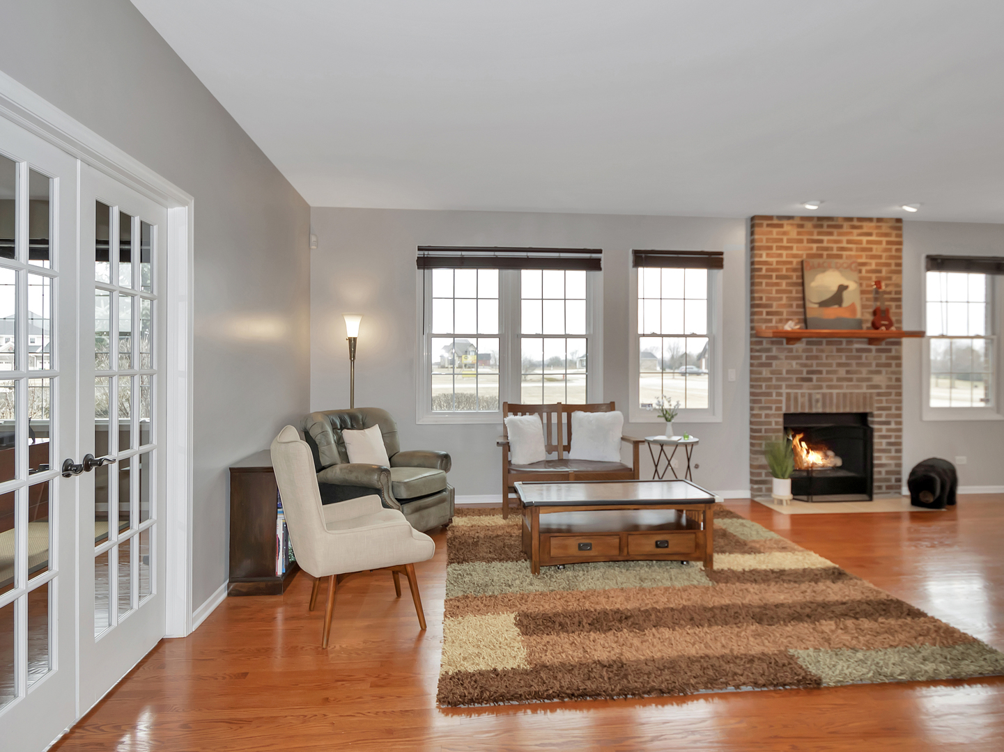 23928 Roberts Street Manhattan, IL 60442 - Photo 14 of 36 a living room with furniture and a fireplace