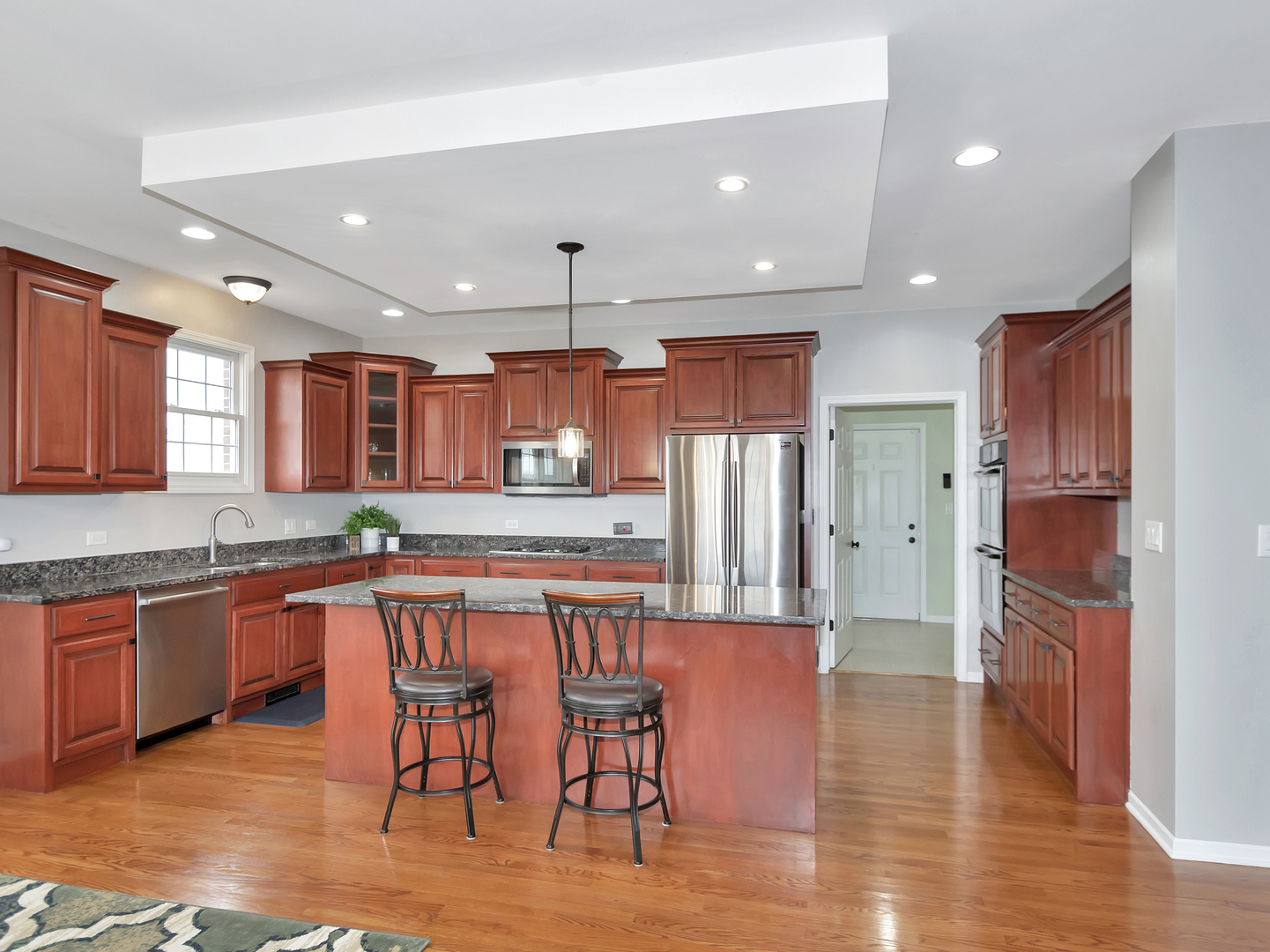 23928 Roberts Street Manhattan, IL 60442 - Photo 19 of 36 a large kitchen with cabinets table and chairs