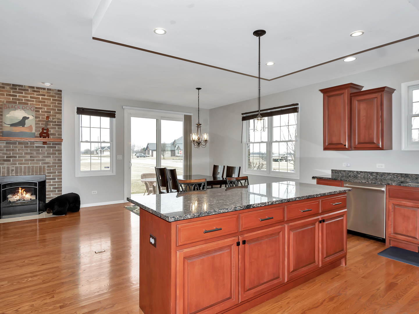 23928 Roberts Street Manhattan, IL 60442 - Photo 21 of 36 a kitchen with stainless steel appliances granite countertop wooden cabinets a stove a sink and a large window