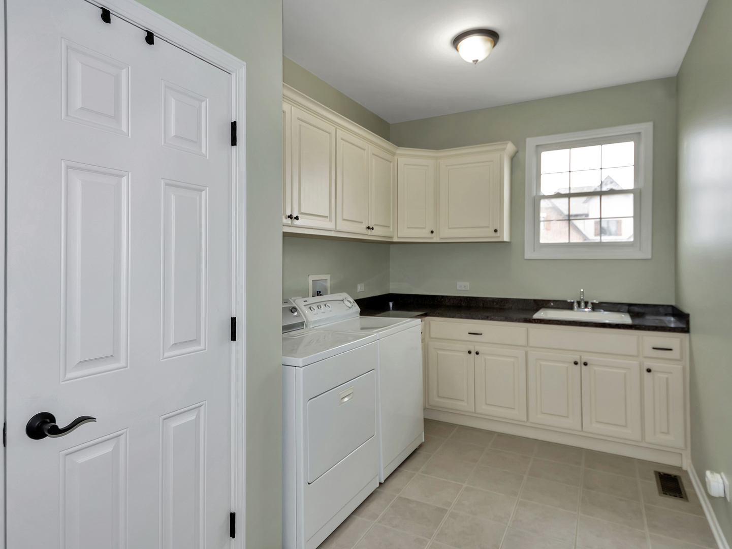 23928 Roberts Street Manhattan, IL 60442 - Photo 25 of 36 a kitchen with granite countertop white cabinets and sink