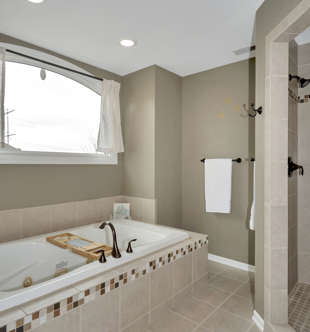 23928 Roberts Street Manhattan, IL 60442 - Photo 31 of 36 a bathroom with a bathtub and a window