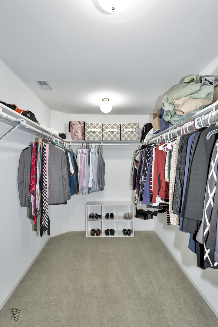 23928 Roberts Street Manhattan, IL 60442 - Photo 32 of 36 a view of walk in closet with clothes