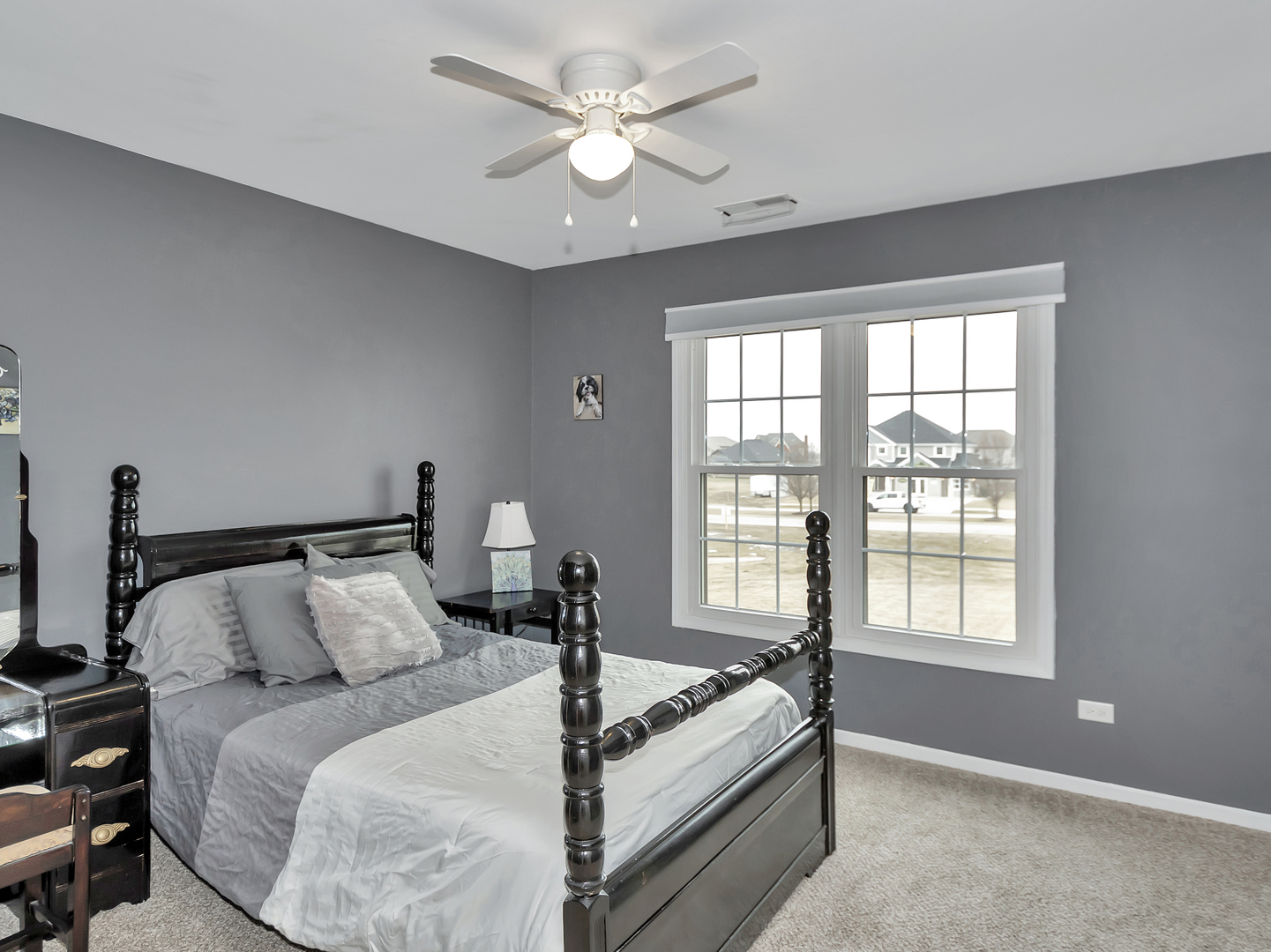 23928 Roberts Street Manhattan, IL 60442 - Photo 33 of 36 a bed room with a bed and a chandelier