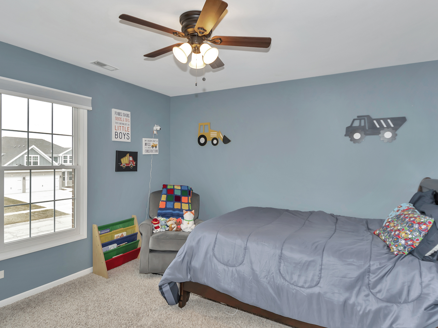 23928 Roberts Street Manhattan, IL 60442 - Photo 35 of 36 a bedroom with a bed and a chandelier