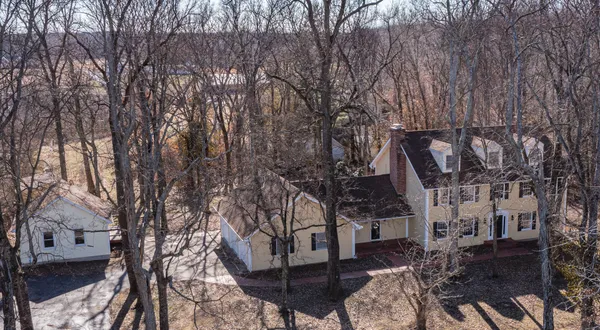 a view of a house with a yard and tree s