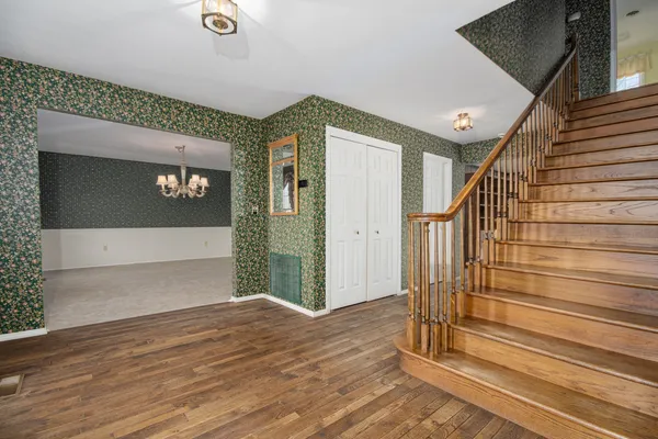 a kitchen with stainless steel appliances granite countertop a refrigerator a sink and a stove