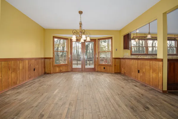 a big room with closet and wooden floor