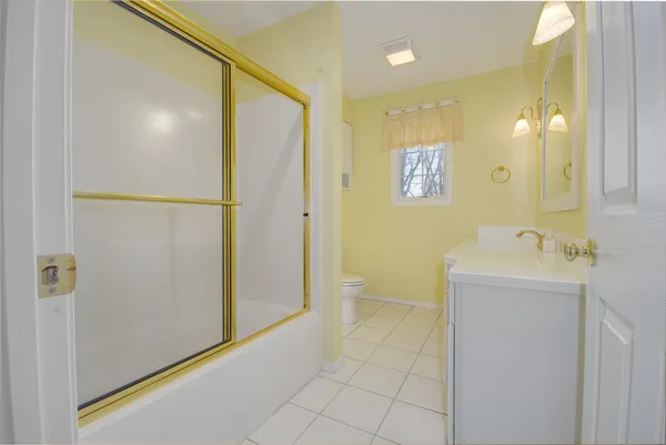 a view of a livingroom with wooden floor and staircase