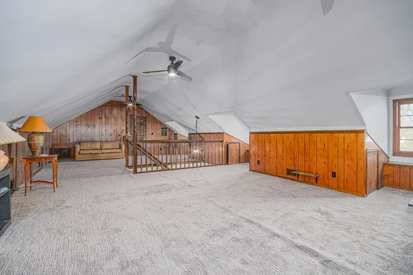 a view of an empty room with glass door and wooden floor