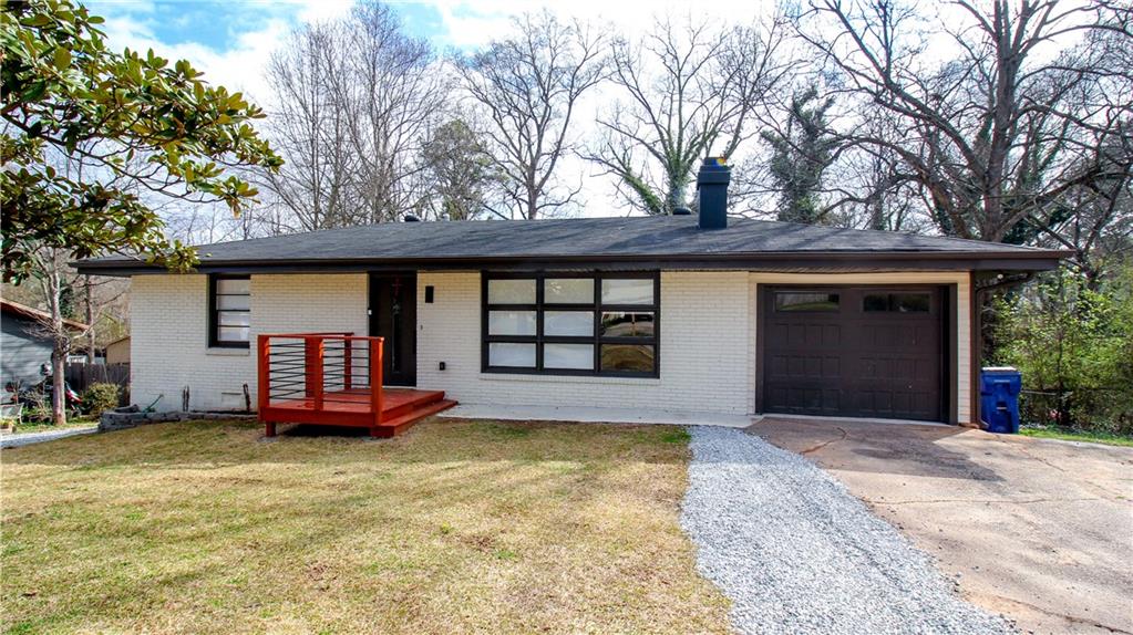 5207 White Boulevard Southwest Mableton, GA 30126 - Photo 1 of 30 a front view of a house with a yard and garage