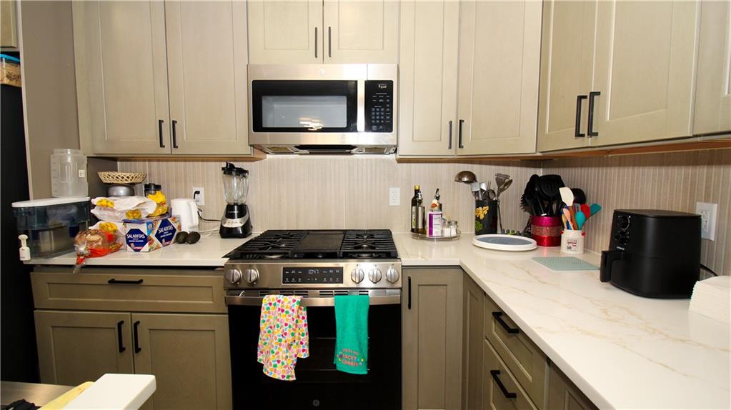 5207 White Boulevard Southwest Mableton, GA 30126 - Photo 16 of 30 a kitchen with stainless steel appliances granite countertop a stove and cabinets