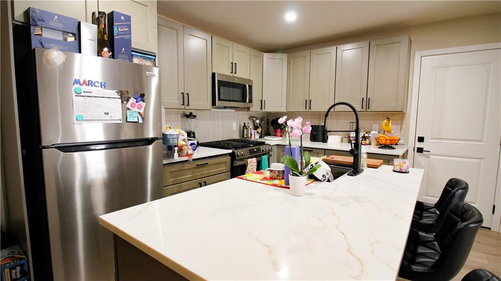 5207 White Boulevard Southwest Mableton, GA 30126 - Photo 17 of 30 a kitchen with refrigerator a microwave a sink and cabinets