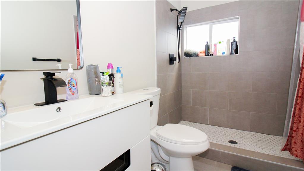 5207 White Boulevard Southwest Mableton, GA 30126 - Photo 26 of 30 a bathroom with a sink a toilet and shower