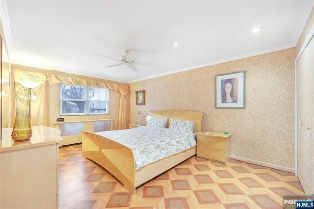 a living room with a bed and next to a window