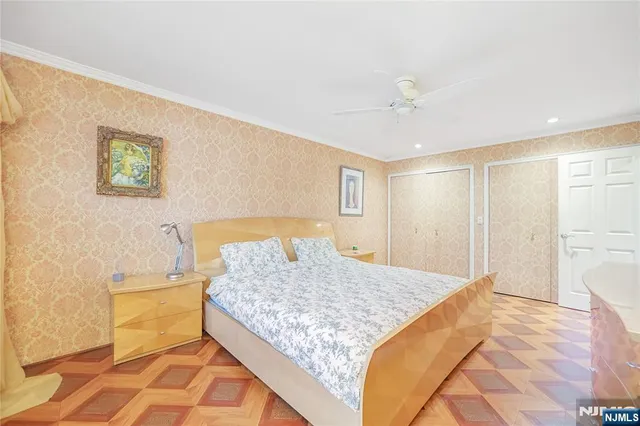 a bedroom with a bed and a painting on the wall