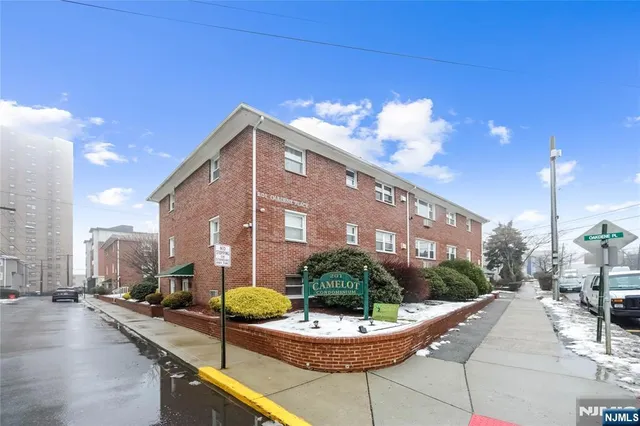 a balcony with furniture and a potted plant