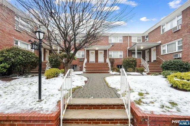 a view of a house with a yard covered in snow