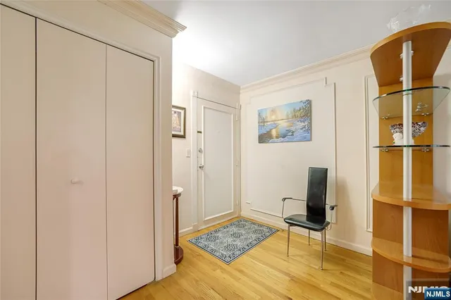 a view of room with wooden floor and bathroom