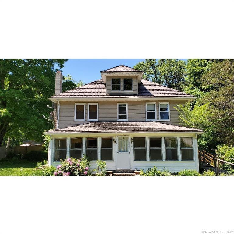 a balcony with a bench and trees