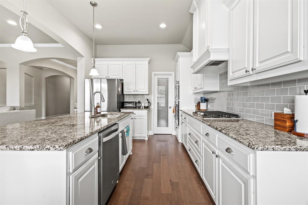 3406 Woodford Drive Mansfield, TX 76084 - Photo 11 of 29 a large kitchen with stainless steel appliances granite countertop a stove oven and a white cabinets