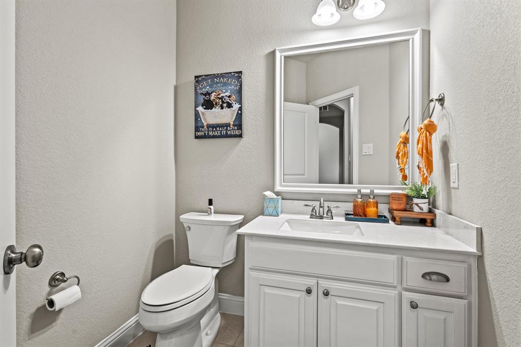3406 Woodford Drive Mansfield, TX 76084 - Photo 16 of 29 a bathroom with a toilet sink and mirror