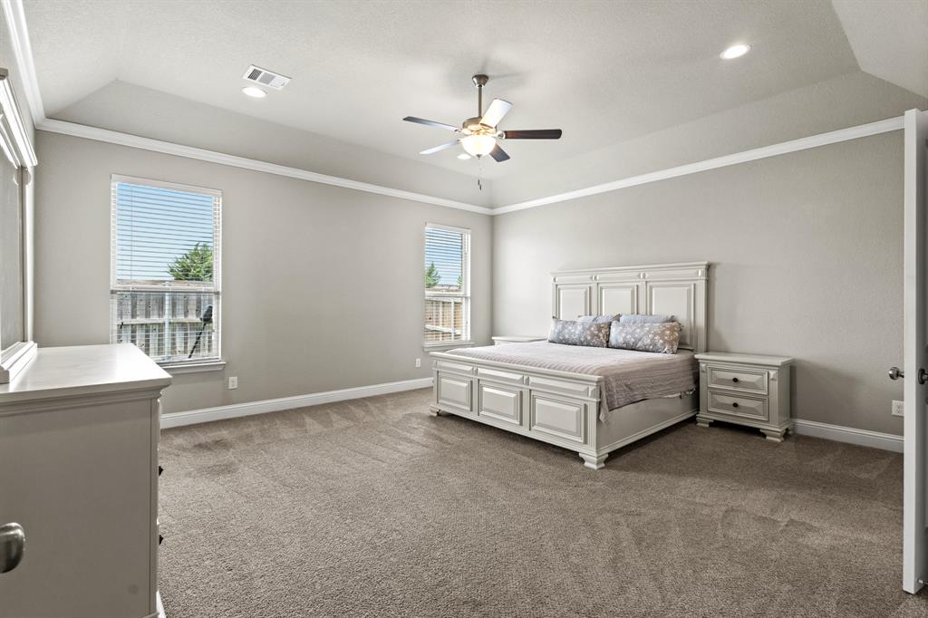 3406 Woodford Drive Mansfield, TX 76084 - Photo 18 of 29 a bed room with a bed and a chandelier