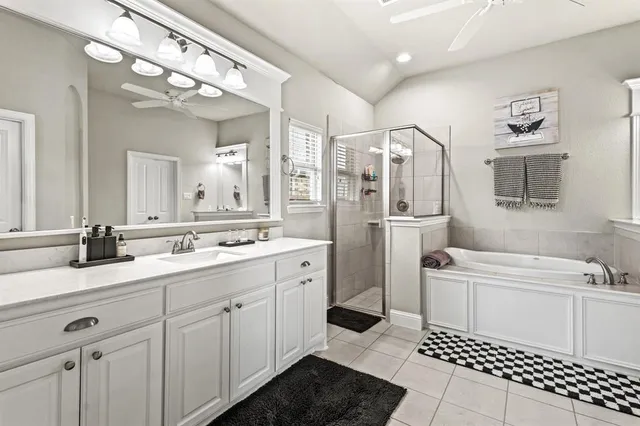 a bathroom with a sink a toilet a shower and a mirror