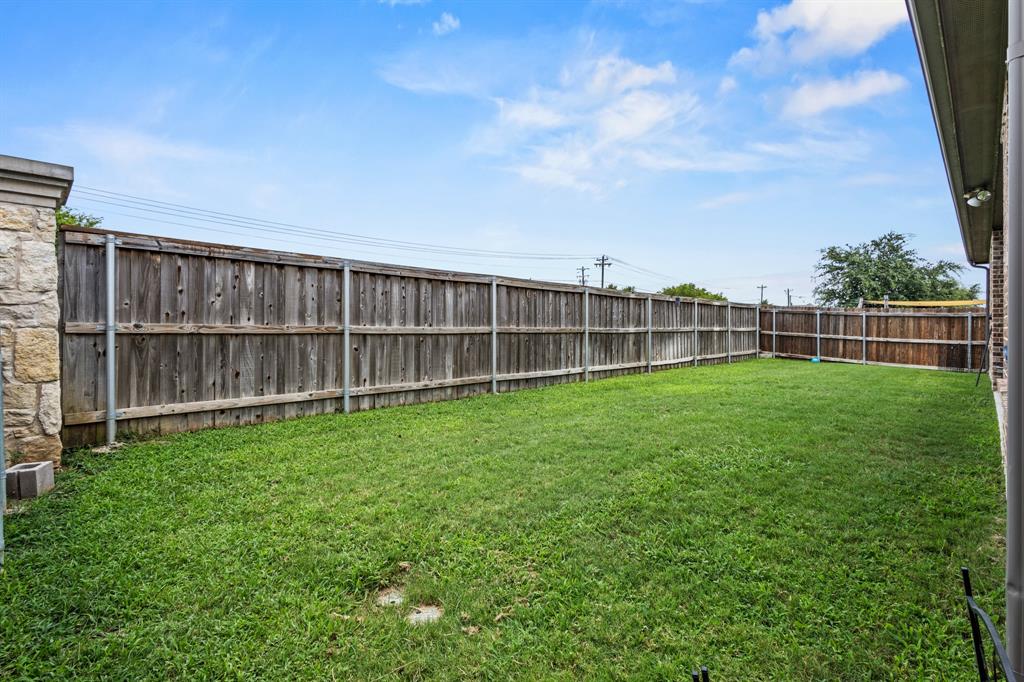 3406 Woodford Drive Mansfield, TX 76084 - Photo 24 of 29 a view of a yard with wooden fence