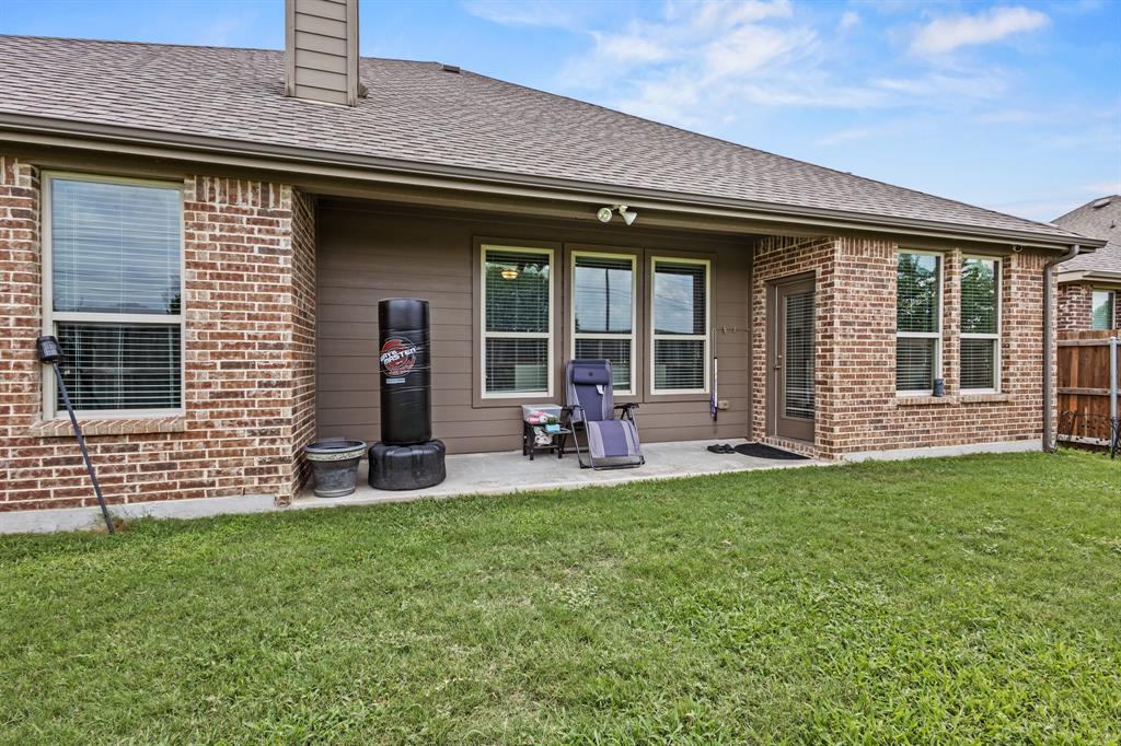 3406 Woodford Drive Mansfield, TX 76084 - Photo 26 of 29 a front view of a house with a garden and porch
