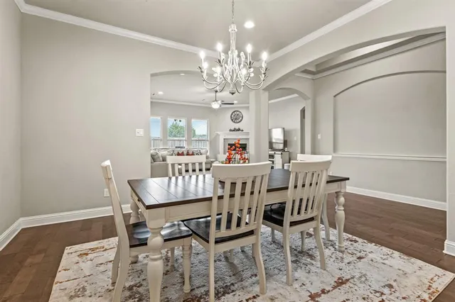 a view of a dining room with furniture and chandelier