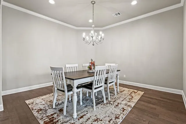 a kitchen with stainless steel appliances granite countertop a kitchen island hardwood floor and a sink