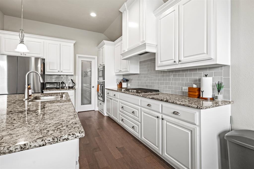 3406 Woodford Drive Mansfield, TX 76084 - Photo 10 of 29 a kitchen with stainless steel appliances granite countertop a sink stove refrigerator and cabinets