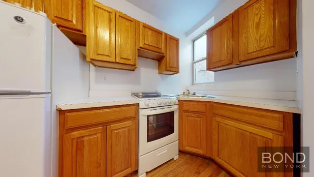a kitchen with stainless steel appliances granite countertop a refrigerator and cabinets